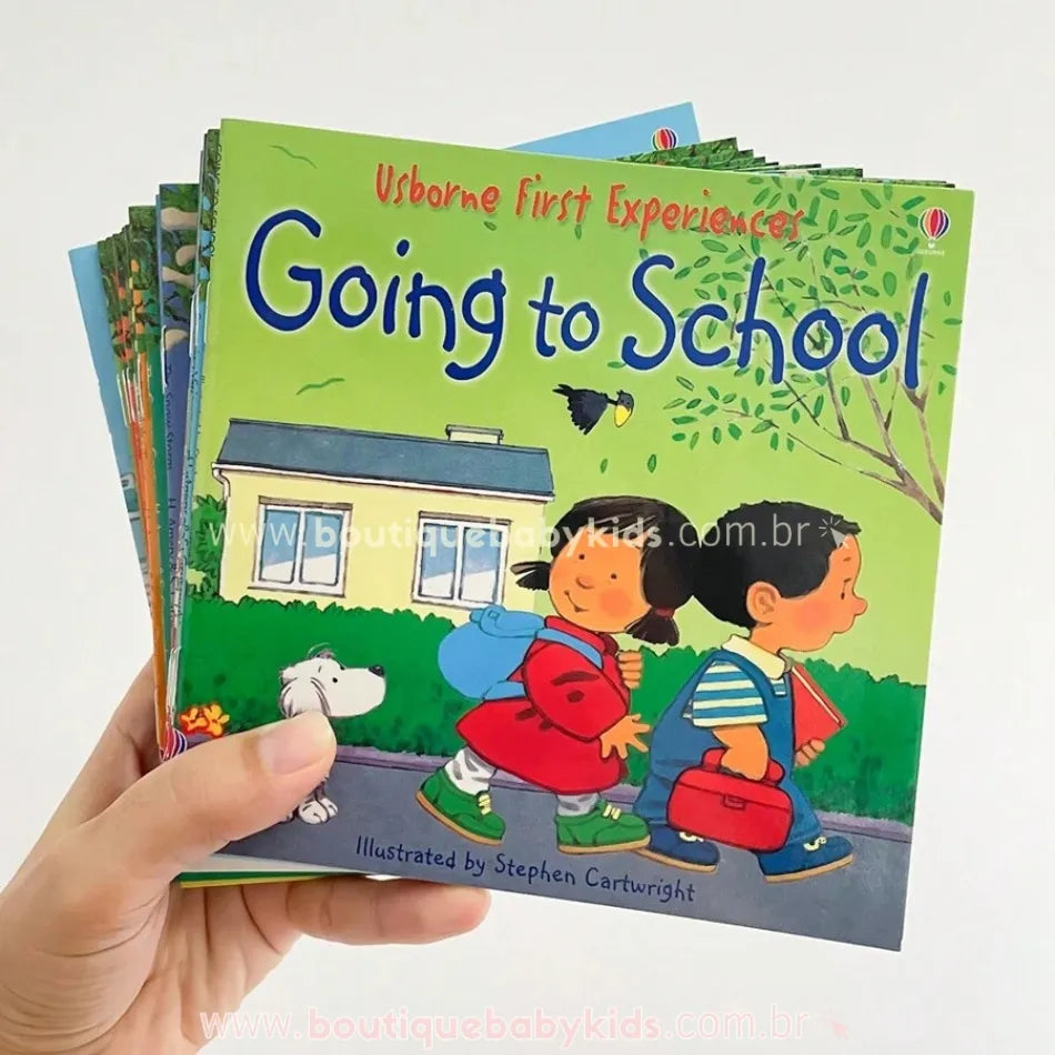Pessoa segurando um conjunto de livros infantis em inglês da coleção Usborne First Experiences, destacando a capa do livro "Going to School".